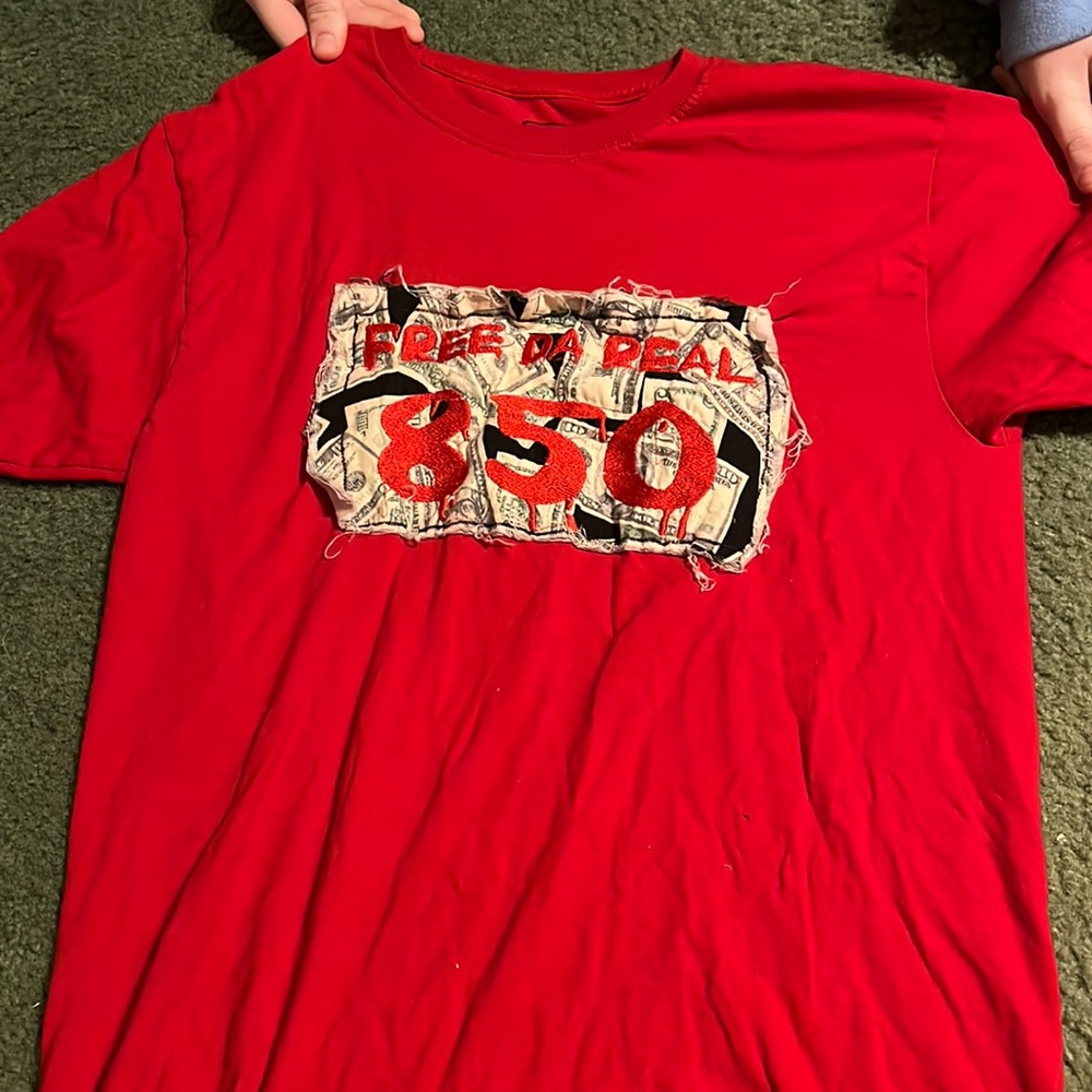 “FREE DA REAL 850” dollar sign shirt. Size 34/36 in women. Barely ever worn.